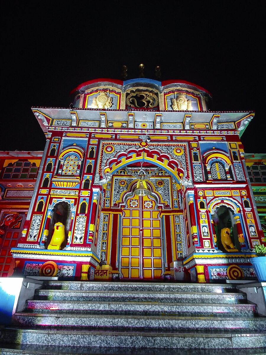 The painted facade of Badrinath temple lit at night